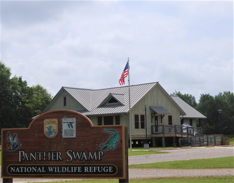 The Panther Swamp NWR Headquarters Office sign with the office in the background