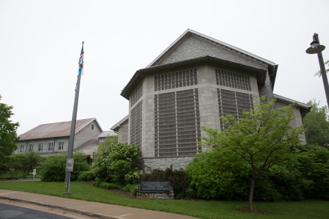 building with sidewalk and bushes 