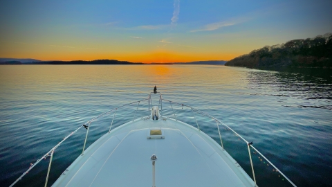 Alabama sunrise over the water, bow of a boat.