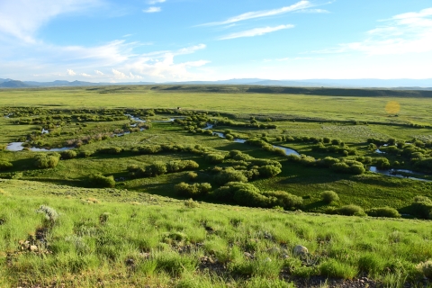 Distant view of a river winding through prairie.