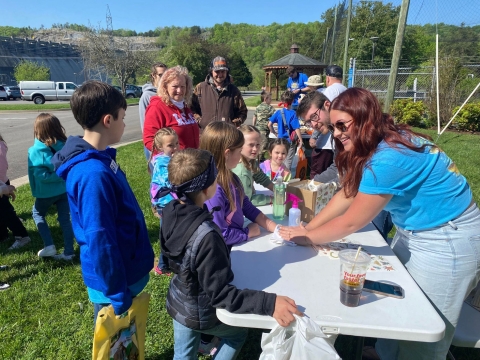 Kids gathered around table getting temporary tattoos