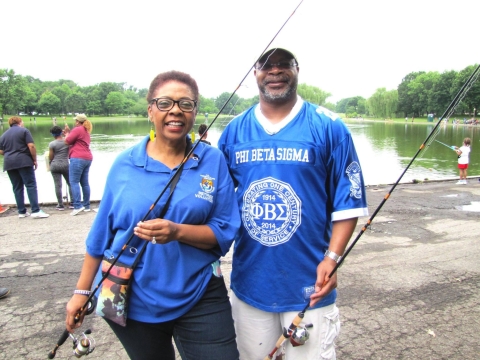 Woman and man holding fishing rods