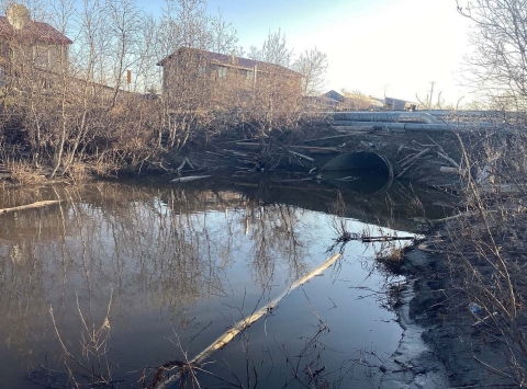 a body of water with a building in the background