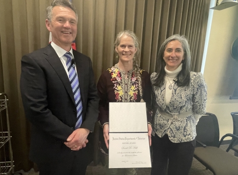 Sarah Hall (center) receives the Meritorious Service Award with Pacific Region Deputy Regional Director Bridget Fahey (right) and Regional Director Hugh Morrison (left