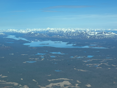 landscape with lakes and snow capped mountains in the distance