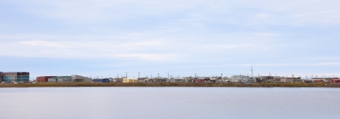 View across a large pond of many colorful buildings