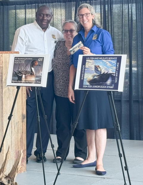 3 smiling people with duck stamps