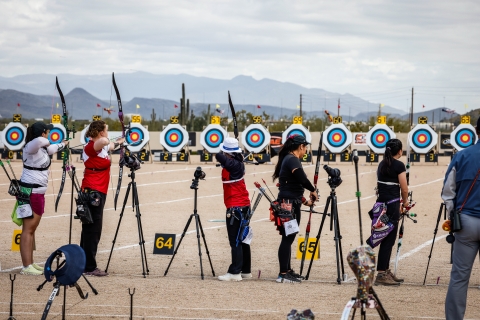 Five archers line up to shoot targets at the Arizona Cup. 