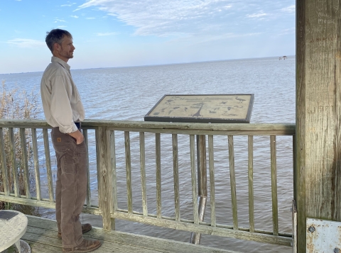 A man looks over a lake.