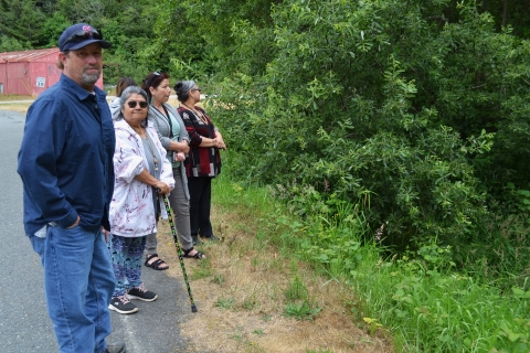 people standing by a road