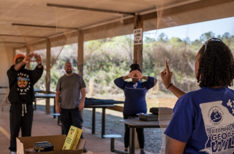 Two Fort Valley State University students at target range hold their hands in front of them as part of a dominant eye test. 