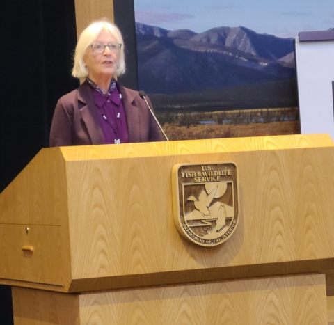 woman speaks at a podium