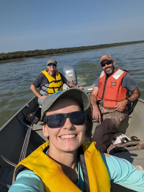 three people in a boat