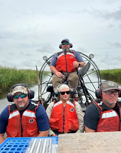 four people in an airboat