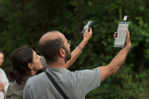 2 people hold up measuring tools