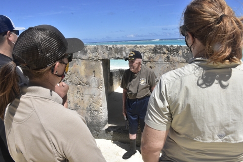 Sergeant Edgar R. Fox stands in front of pill box at Midway Atoll