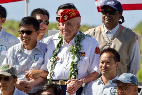 Sergeant Edgar R. Fox smiles among Midway Atoll residents and guests of the 77th Battle of Midway Anniversary 