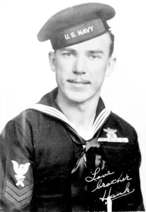 Historic picture of Hank Kuzick smiling wearing Navy uniform