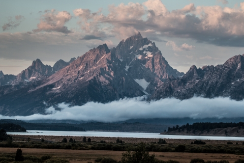 Clouds surround the major peaks of the Teton Range over Jackson Lake and Willow Flats.