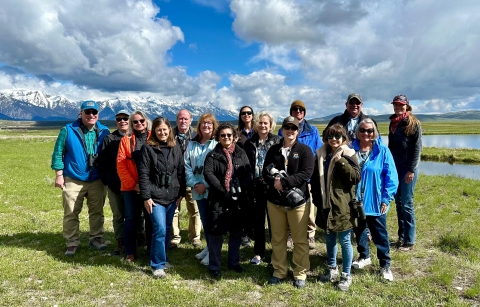 members of the History Committee standing in field with white puffy clouds in the sky