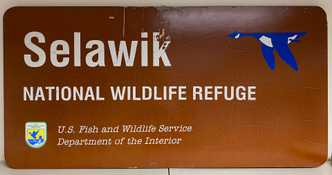 A brown sign with "Selawik National Wildlife Refuge" and logos