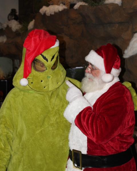 Santa pointing at the Grinch