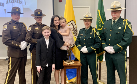 Four members of the Honor Guard flank members of the Wolgamott family at a memorial service. 