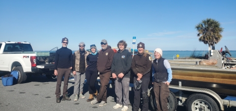 A group of USFWS staff standing in front of the turtle rescue boat