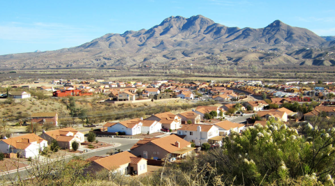 A suburban area with lost of houses and mountains in the background