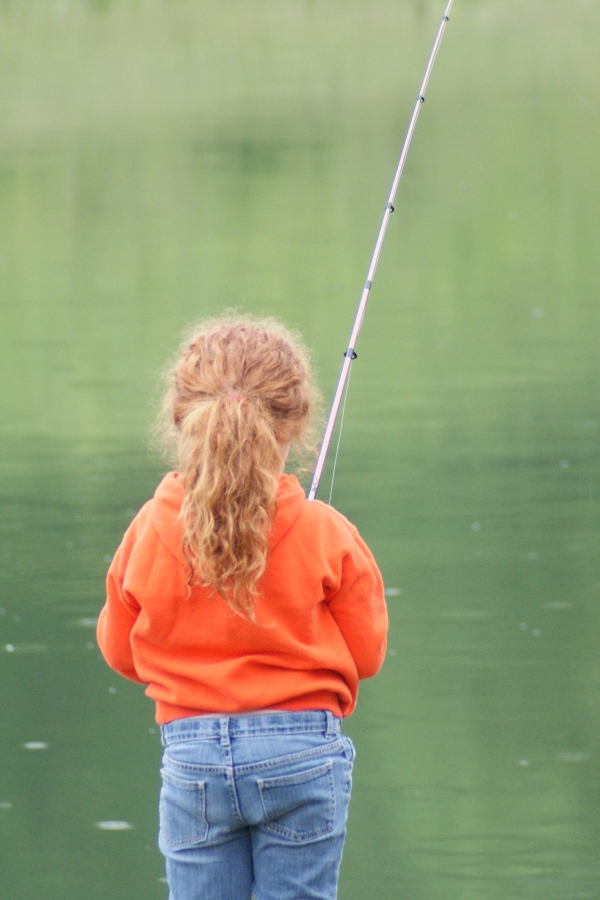 An image of a small child fishing.