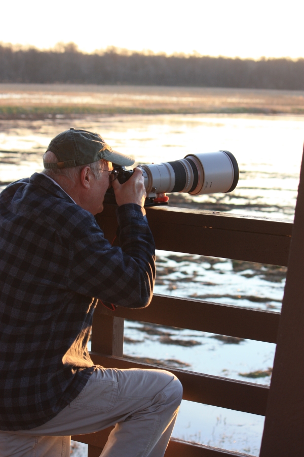 An image of a photographer taking pictures from an observation deck.