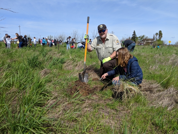 USFWS staff planting with school kids