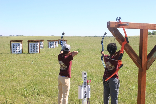 Two archers using the Refuge archery range