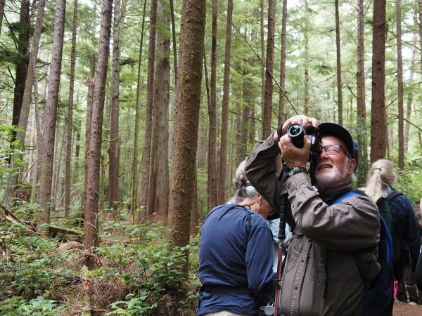 Man using camera to take a photograph.