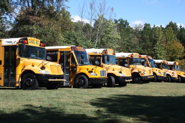 School buses lined up in a field