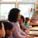 Girl looks at shell in the classroom