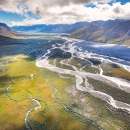 Striking aerial photo of a river bed running between mountain ranges in Alaska.