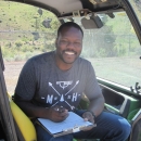 Rikeem Sholes, fish biologist, sitting in an OHV 