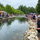 People fishing banks of stream