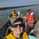 three people in a boat