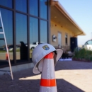 Foreground: USFWS Branded Helmet atop Hazard Cone. Background: Visitor Center of Rocky Mountain Arsenal National Wildlife Refuge