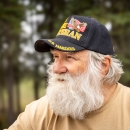 Man with a beard wearing a Marine veteran hat