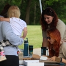 Two staff members work a booth educating visitors about native bees