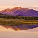 A mountain with grasslands and a wetland at Lower Klamath National Wildlife Refuge during sunset