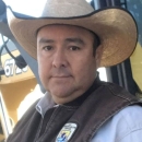 A portrait of man in a hat and a U.S. Fish and Wildlife Service uniform