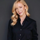 Headshot of Rosalie Wetzel in front of dark grey backdrop.