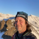 man in a hat on a snowy mountain