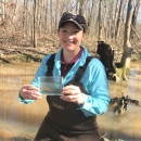 Jennifer Grunewald holding a Trispot Darter in a viewing container.