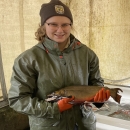 Biological science technician Rebekah holding a brook trout