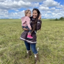 a woman holding a young girl in a field